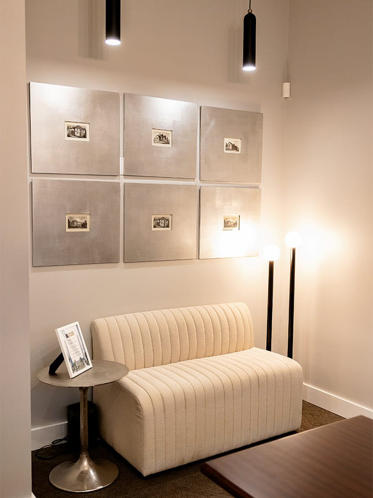 Stylish cozy commercial interior with elegant sofa and warm pendant lighting — Bellevue, Ariana Designs