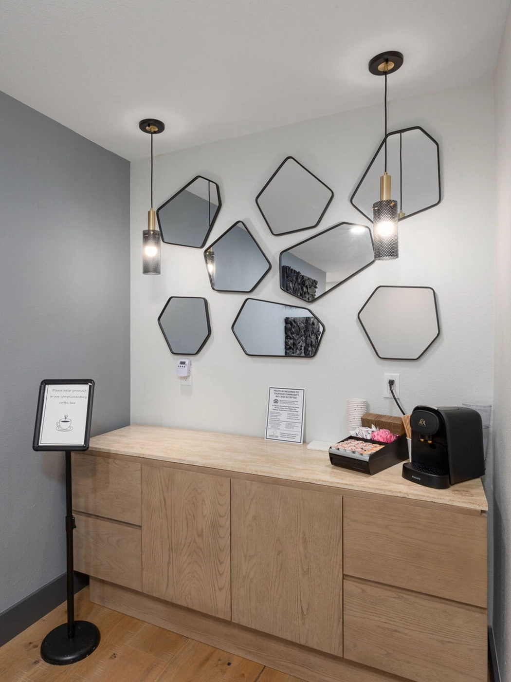 Modern reception area hexagonal mirrors warm wood countertop — Ariana Designs, Hidden Oaks