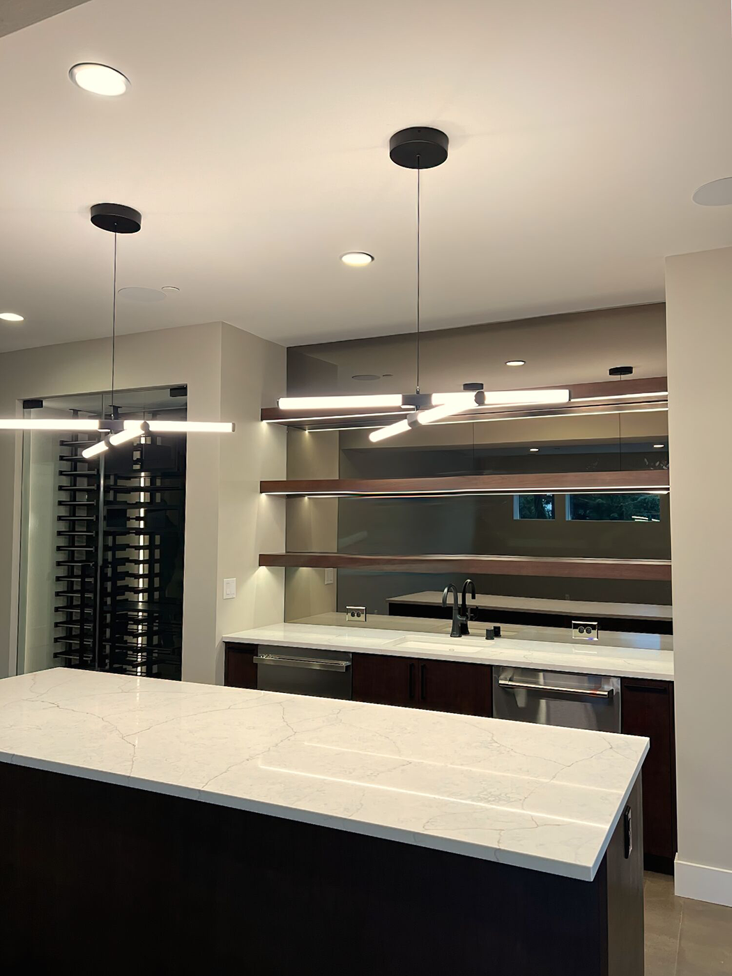 Minimalist bar interior with white stone island and pendant lights — Medina Underground, Ariana Designs