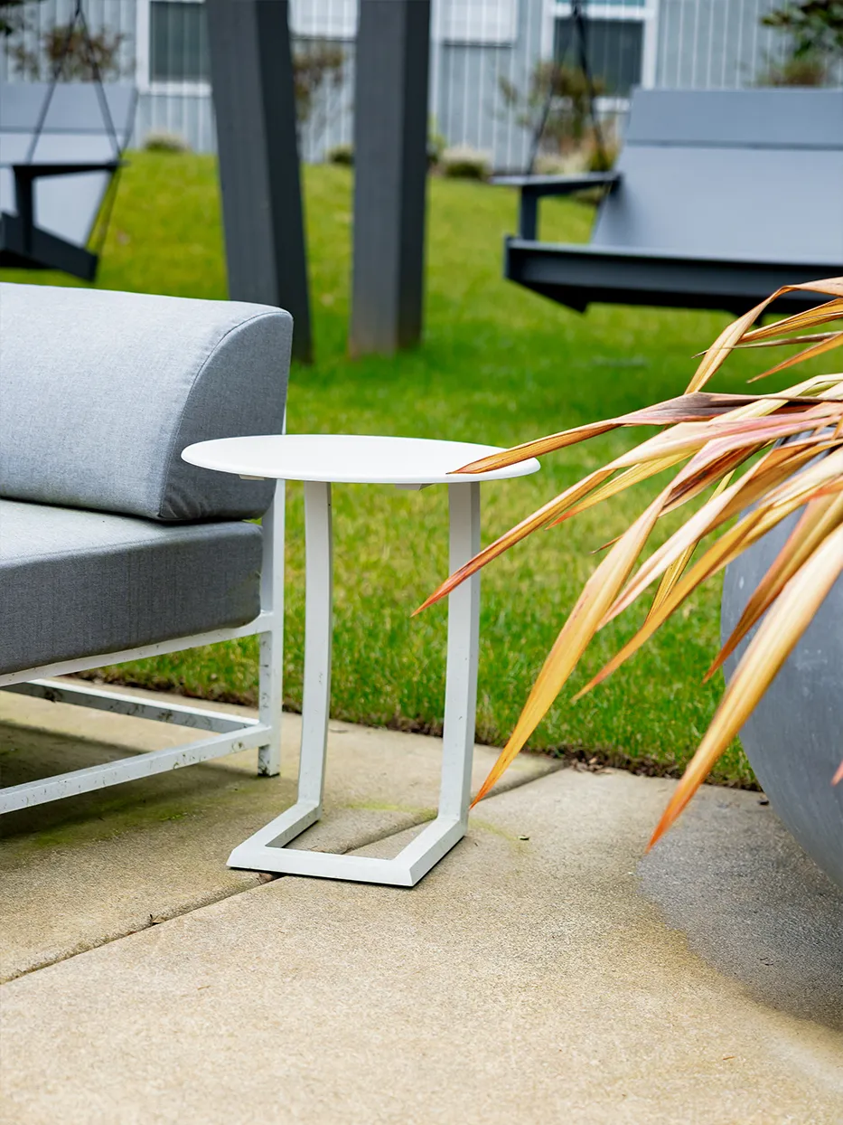 Modern outdoor sofa side table green setting — Ariana Designs, Bellevue Washington