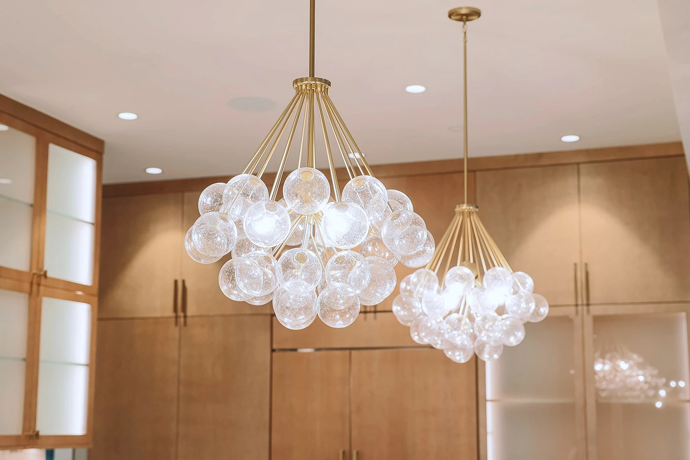 Elegant glass sphere pendant chandeliers in modern kitchen interior — Ariana Designs