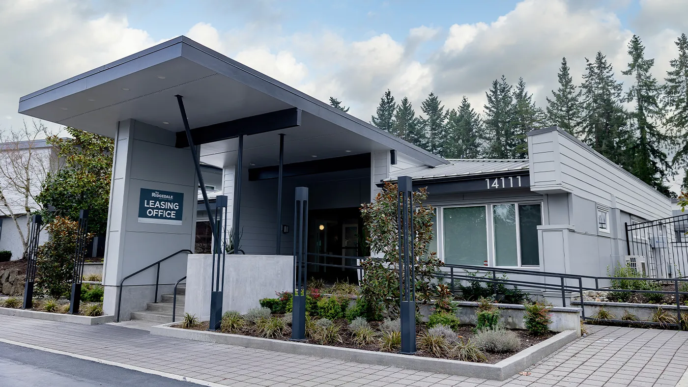 Modern Ridgedale Leasing Office with inviting entrance and beautiful landscaping in serene setting.