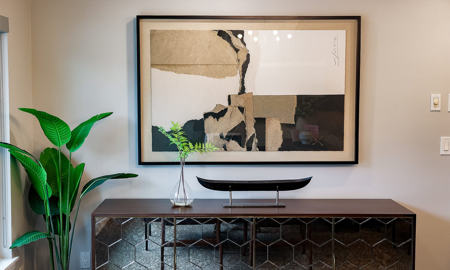 Modern interior with wooden console, large-scale abstract art, and lush greenery — Bellevue office, Ariana Designs