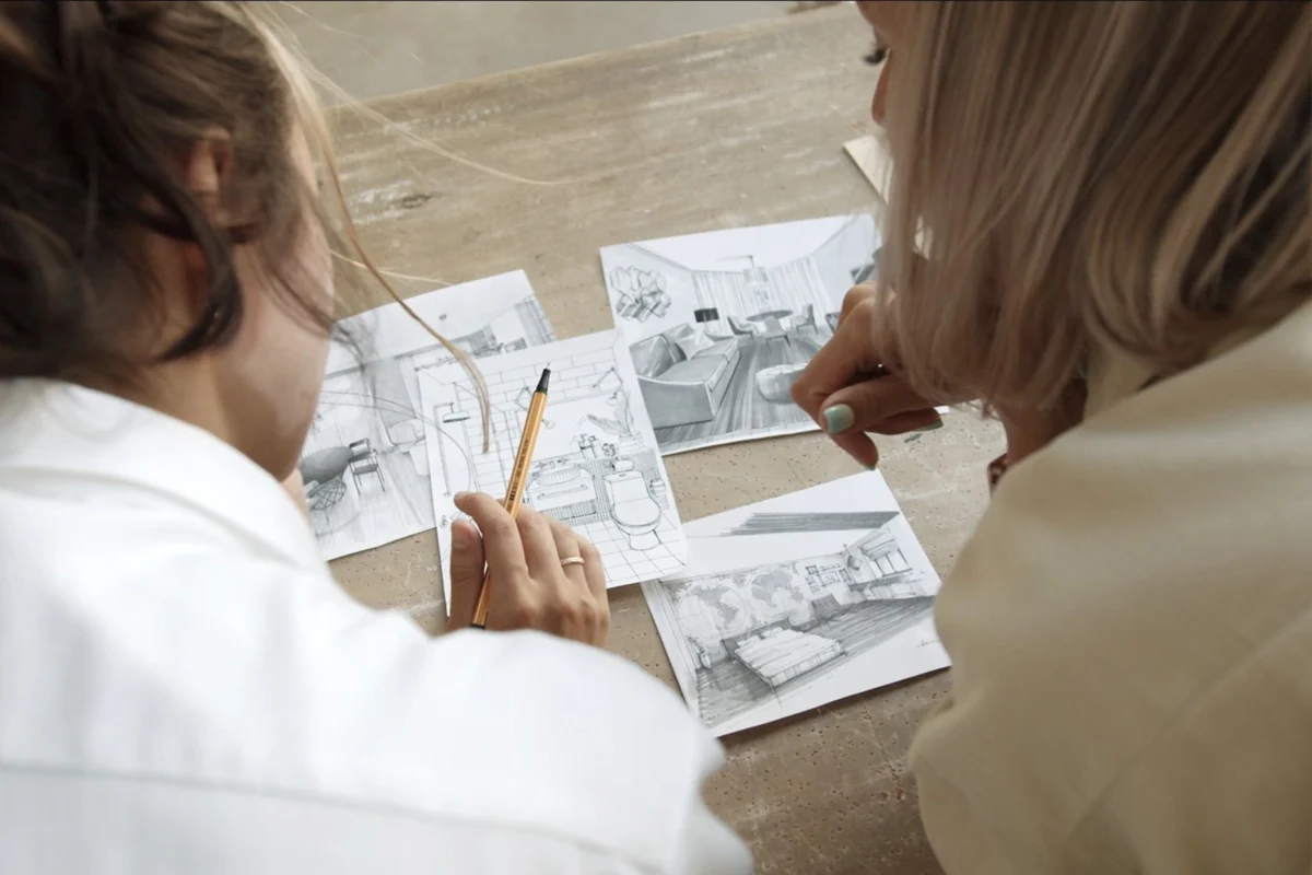 Interior designer discussing ideas with a client during a consultation session at Ariana Designs and Architecture.