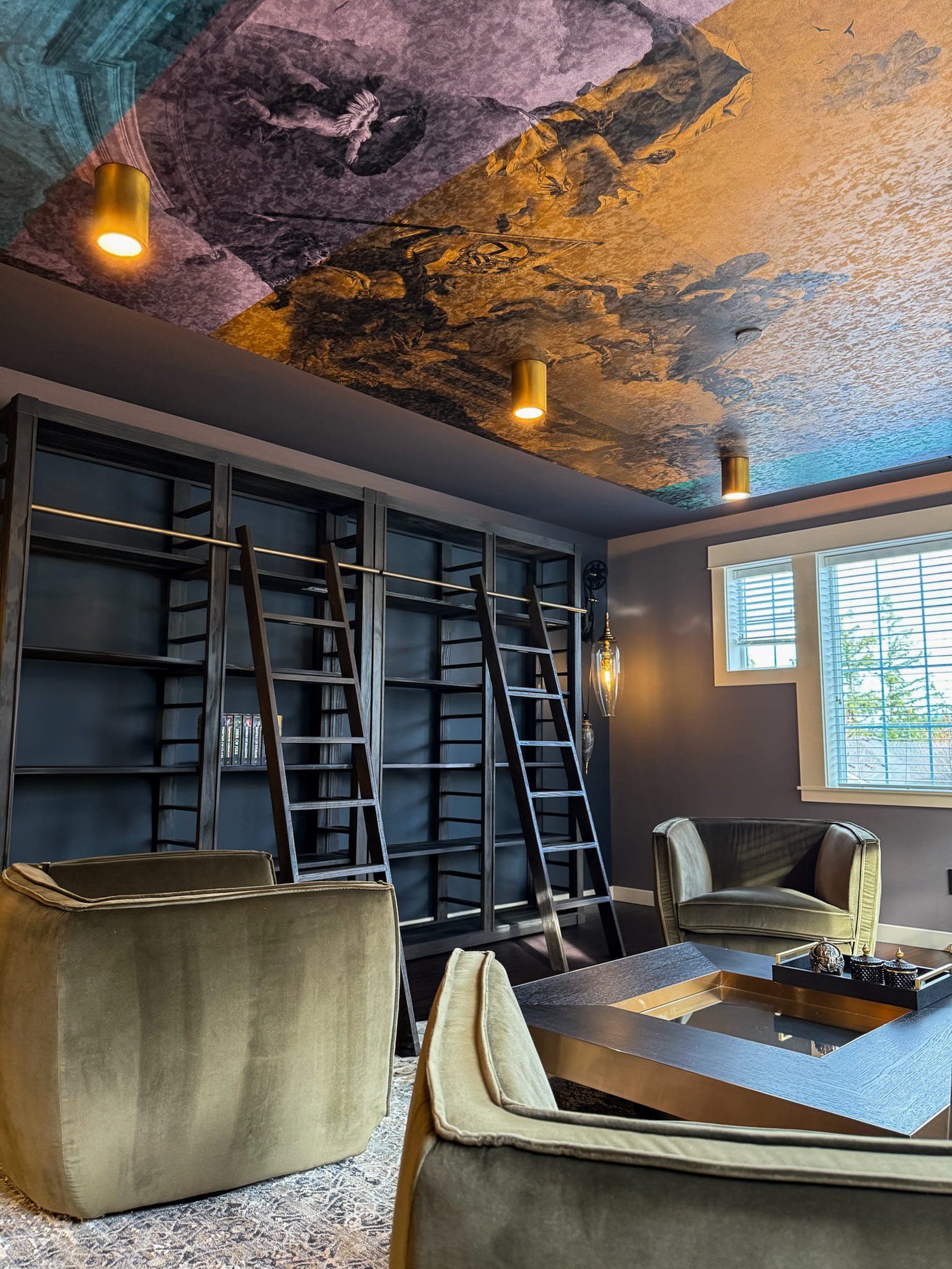 Stylish modern reading room featuring a luxurious ceiling, velvet chairs, and elegant lighting.