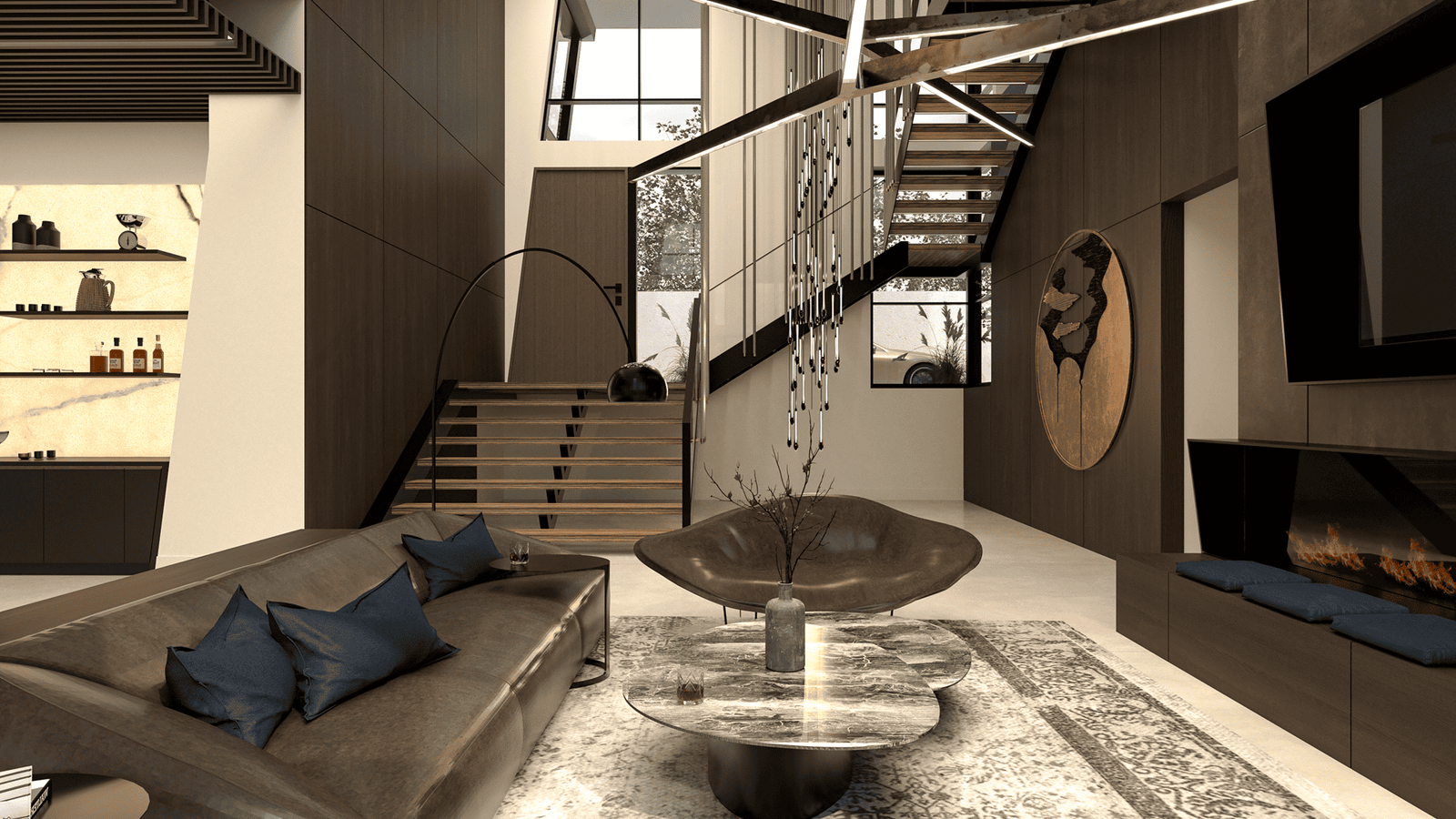 Modern waterfront lounge featuring a linear fireplace wall, sculptural ceiling lights, custom sofa, and a circular bronze art piece beside an open-riser staircase — Ariana Designs & Interiors